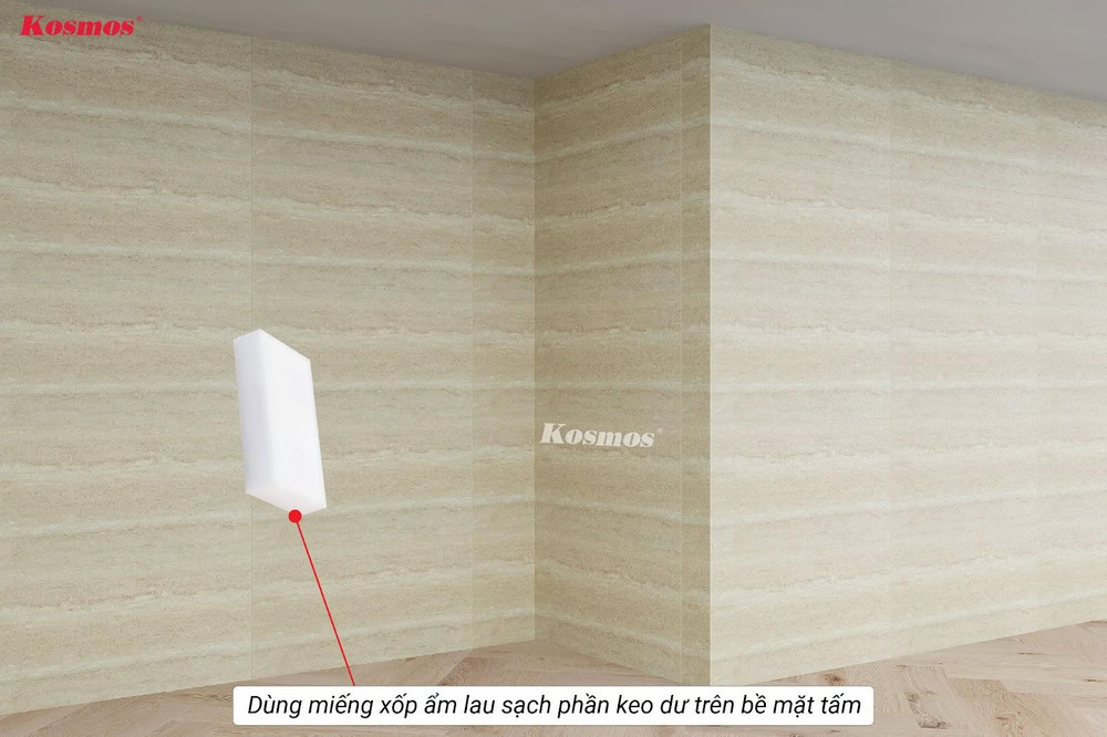 Dùng miếng xốp ẩm lau sạch phần keo dư trên bề mặt tấm