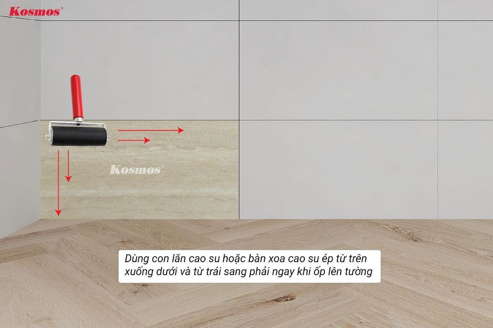 Ngay lập tức dùng con lăn cao su hoặc bàn xoa cao su ép từ trên xuống dưới và trái sang phải